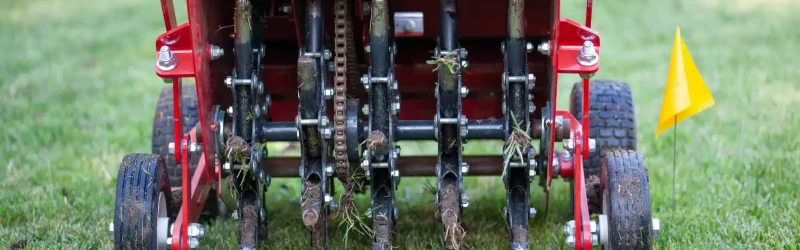 Red machine aerating a lawn in Omaha, Nebraska.